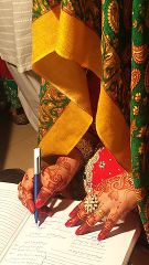 File:Bride signing marriage papers.jpg